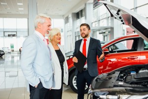 Agent and Couple Talking in Dealership about Motorcycle Insurance in Allen, Dallas, Frisco, McKinney, Plano, Rylie