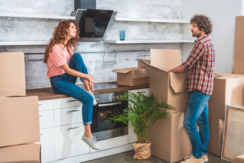 couple unpacking boxes after moving into home with Home Insurance in Waxahachie, TX